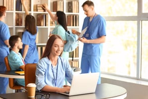 A vet sitting at a laptop taking online CPD