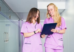 Two veterinary nurses share a joke while discussing their CPD requirements