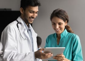 A vet helps a new graduate vet with a task