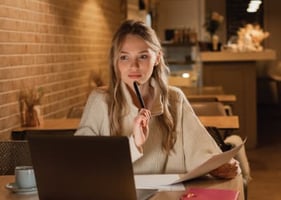A vet sits by her laptop, trying to decide who to take her veterinary certificate with